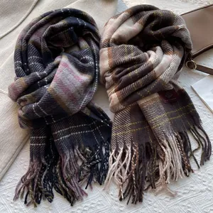Detailed view of soft vintage plaid scarves with tassels and textured fabric weave