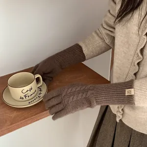 Deep brown wool blend cable knit gloves for winter with minimalist logo and ribbed cuffs