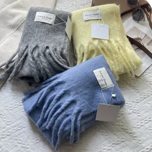 Thick knitted tassel scarves in grey, yellow, and blue with premium wool-like texture