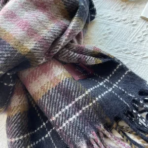 Detailed view of retro plaid scarf showing colorful checkered patterns and fringe edges