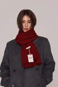 Close-up of handmade 100% Australian wool knit scarf in deep burgundy on a model