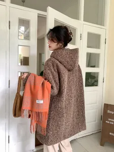 Detail of soft orange plaid wool scarf with fringe tassels for winter warmth