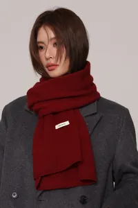 Close-up of 100% pure wool scarf texture with sewn-in quality material label