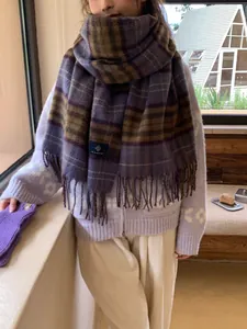 Close-up of thick checkered scarf in purple and brown with soft fringe tassels