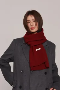 Close-up of a burgundy Australian wool scarf featuring a 100% WOOL material label