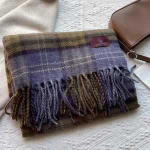 Detail of soft plaid scarf with fringe tassels and YF BLOSSOM brand label tag