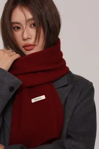 Close-up of deep red 100% Australian wool scarf featuring fine knitted texture
