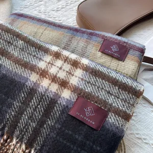 Detailed macro of vintage plaid scarves with tassels and premium woven brand label