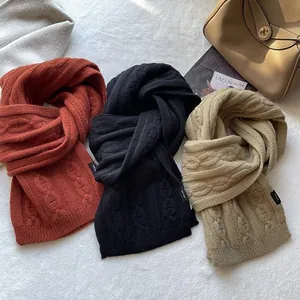 Detail of 100% pure wool scarves with pig nose jacquard knit and brand tags