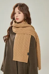 Detail view of camel wool scarf showing cable knit pattern and premium 100% wool texture