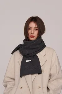 Detail of 100% wool scarf showing high-quality texture on a stylish wool coat