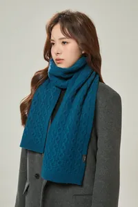 Detail of navy cable knit wool scarf with 100% wool label and thick texture