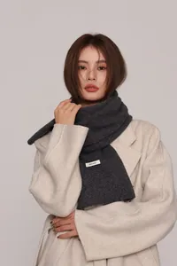 Detailed close-up of 100% Australian wool knit scarf texture and authentic material label