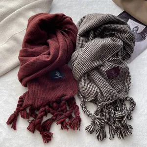 Écharpes d'hiver épaisses à carreaux et rouge vin avec longues franges sur fond en peluche