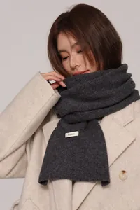 Close-up of premium dark grey 100% Australian wool knitted scarf with textured grain