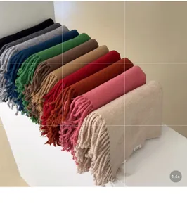 Close-up of premium solid wool scarves collection with elegant tassel fringe details