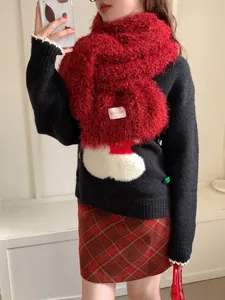 Detail view of red fluffy wool scarf with BOWLOW label paired with black knit sweater