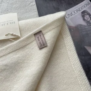 Close-up of 100% pure wool scarf with handmade label and high-quality knit texture