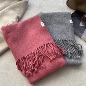 Pure wool scarves in pink and grey with tassels and autumn lifestyle props