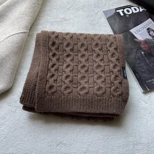 Detailed macro view of 100% pure wool scarf featuring thick chunky knit texture