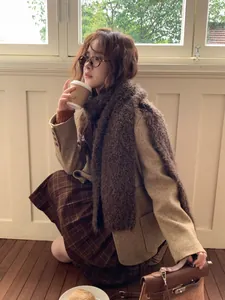 Close-up of cozy dark brown wool scarf paired with a khaki blazer and checkered skirt