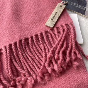 Close-up of soft wool scarf texture showing fine fibers and fringe details