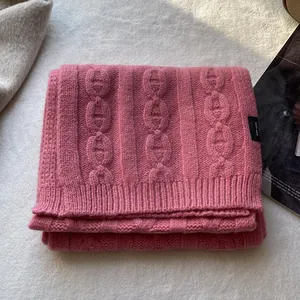 Detailed view of pink 100% wool knit scarf featuring premium chain-link textured pattern