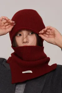 Close-up of wine red 100% pure wool knitted beanie and matching neck warmer texture