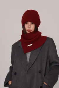 Detailed view of the 100% pure wool label on the deep burgundy knitted beanie hood