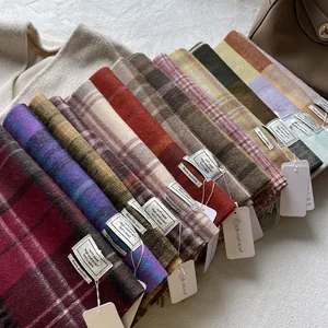 Assorted 100% wool scarves in chic blue plaid and multiple colors for winter warmth