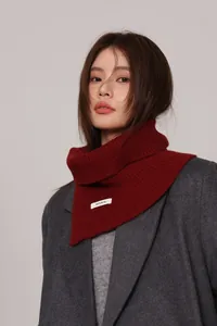Detail of burgundy 100% wool ribbed knit turtleneck collar with a soft texture