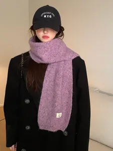 Detail of lilac purple wool blend scarf with subtle colorful specks and stitched label