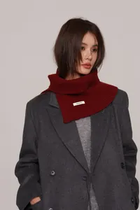 Detail of 100% pure wool red knit neck warmer with ribbed texture and soft wool material