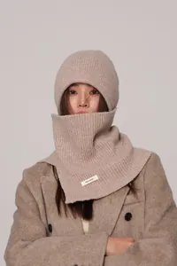Detailed macro view of 100% pure wool label on beige knitted balaclava hood