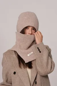 Detail of oatmeal wool knit hat and neck warmer set showing 100% WOOL material label