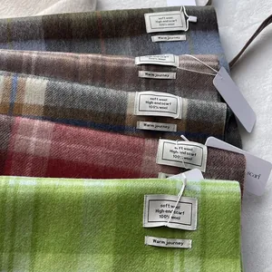 Classic 100% Australian wool plaid scarves in various colors shown in a soft stacked display
