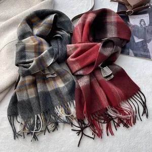 Detailed close-up of 100% wool checkered scarves with classic fringe and soft texture