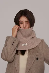 Detail showing 100% pure wool texture on a chunky knit neck warmer and turtle neck scarf