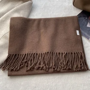 Detail of 100% pure wool scarf texture with elegant fringes and luxury fabric label
