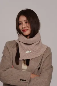 Detail of pure wool knit neck warmer featuring a 100 percent wool fabric woven label