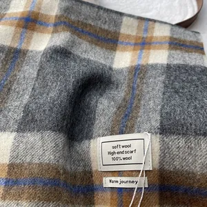 Detail shot of 100% Australian wool scarf featuring classic plaid texture and soft fabric