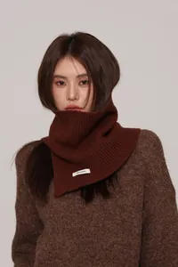 Detail of 100% pure wool caramel brown ribbed knit collar with white textile label