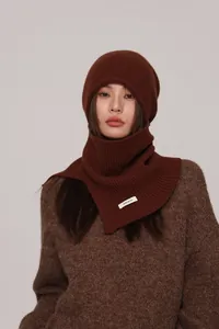 Detail of dark brown 100% wool knit balaclava showing soft texture and composition label