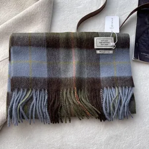 Detail of 100% wool scarf featuring classic plaid patterns and elegant thick tassels
