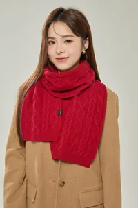Detail of red cable knit 100% merino wool scarf with authentic material label tag