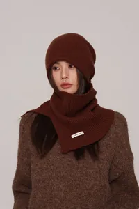 Detail of coffee brown knit hat and scarf set with 100% wool woven label on neck warmer