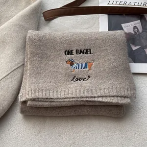 Oatmeal knit scarf featuring dachshund embroidery and ONE BAGEL text for winter