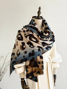 Detailed close-up of soft leopard print scarf with fringe edges and thick wool-like texture
