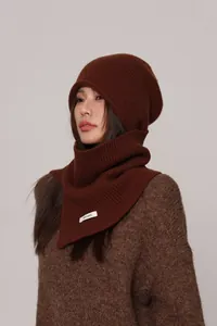 Detailed close-up of dark brown 100% pure wool knitted beanie and matching neck warmer