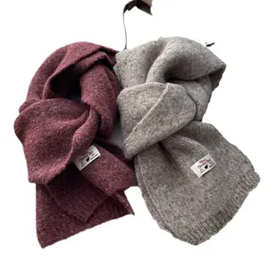 Chunky wool blend knit scarves in burgundy and light gray with woven labels